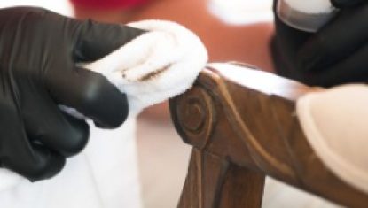 Close up of a Furniture Medic repairing an armrest